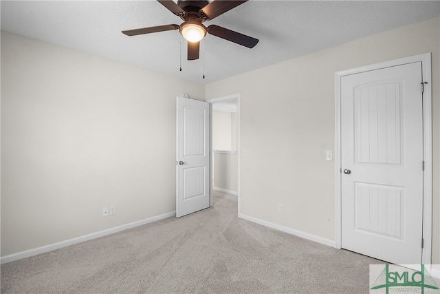 unfurnished bedroom with ceiling fan and light carpet