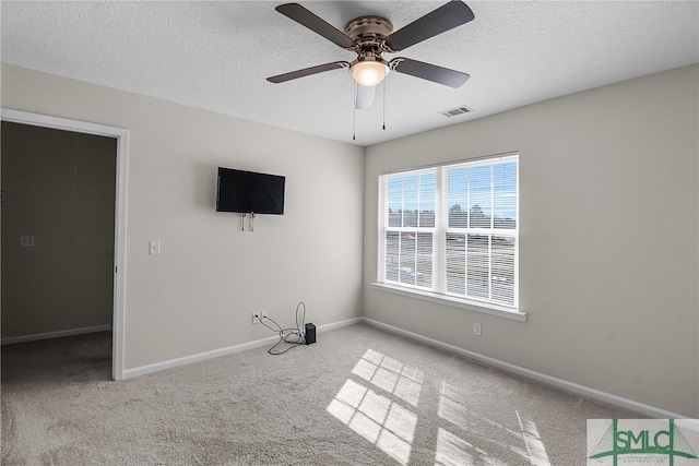 interior space with a textured ceiling and ceiling fan