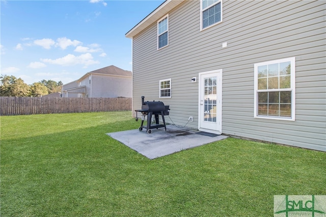 rear view of house featuring a yard and a patio