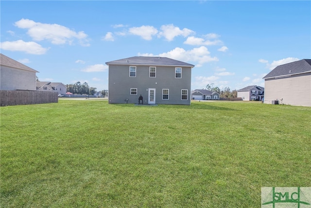 rear view of property featuring a yard