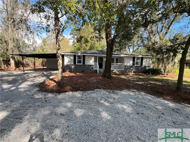 ranch-style home with a porch and a carport