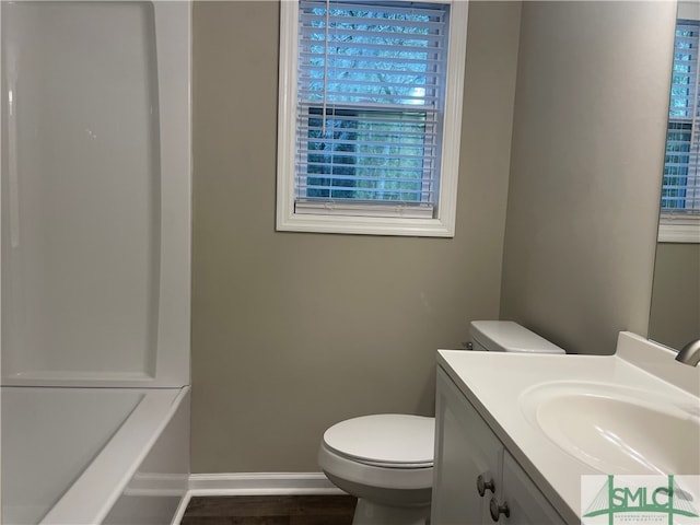 bathroom featuring vanity, hardwood / wood-style flooring, and toilet