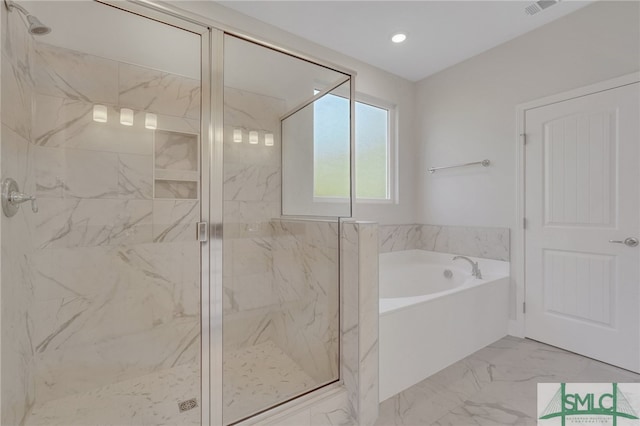 bathroom featuring shower with separate bathtub