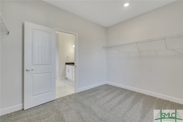 spacious closet featuring light carpet