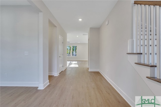 hallway with light hardwood / wood-style flooring