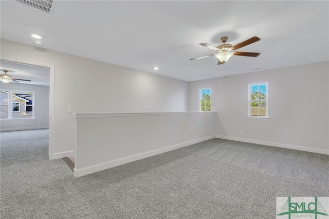 unfurnished room with carpet flooring and ceiling fan