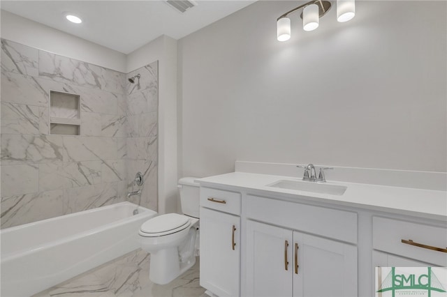 full bathroom with vanity, toilet, and tiled shower / bath