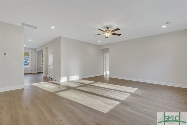 empty room with ceiling fan and light wood-type flooring