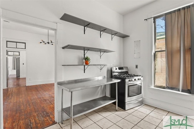 kitchen featuring gas stove and light tile patterned floors