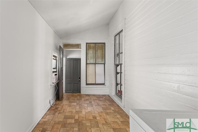 corridor featuring vaulted ceiling