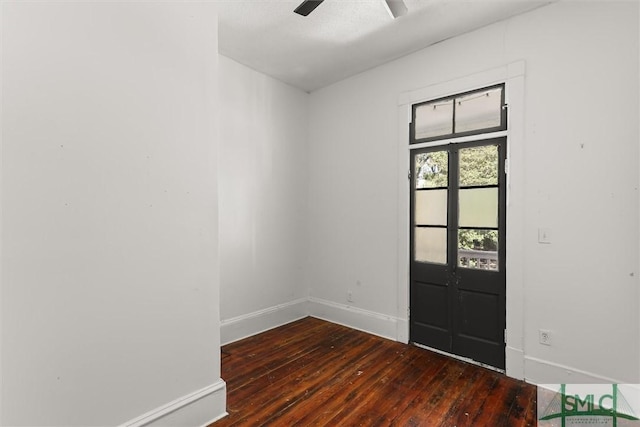 unfurnished room featuring ceiling fan, french doors, and dark hardwood / wood-style floors