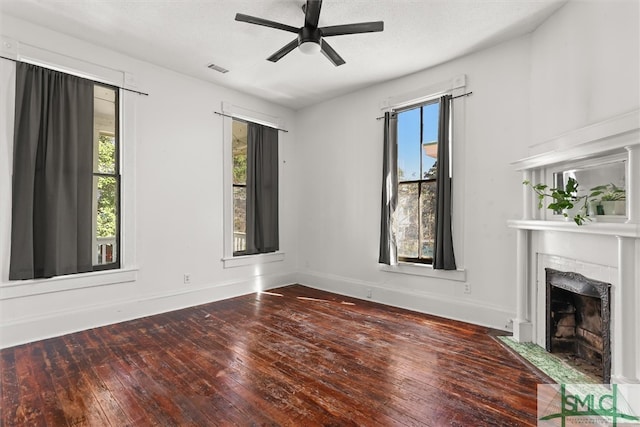 interior space with a textured ceiling, hardwood / wood-style flooring, and ceiling fan