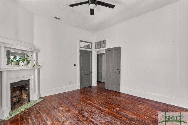 unfurnished living room with ceiling fan and dark hardwood / wood-style flooring