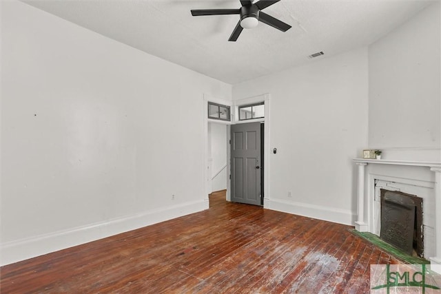 unfurnished living room featuring ceiling fan and hardwood / wood-style floors