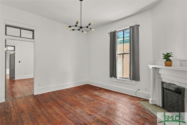 unfurnished dining area featuring hardwood / wood-style floors and an inviting chandelier