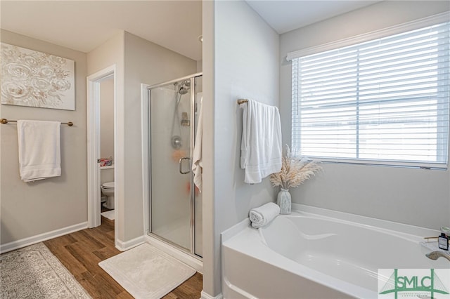 bathroom featuring plus walk in shower, wood-type flooring, and toilet