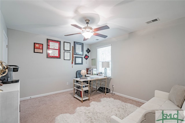 carpeted office space with ceiling fan