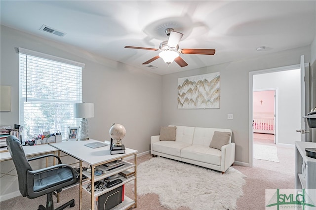 carpeted office featuring ceiling fan