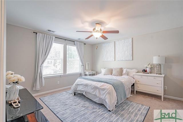 bedroom featuring light colored carpet and ceiling fan