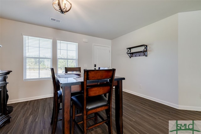 dining area featuring dark wood-type flooring