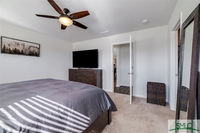 bedroom with ceiling fan and light colored carpet