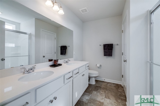 bathroom featuring vanity, toilet, and a shower with door