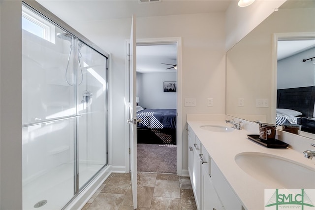 bathroom with ceiling fan, a shower with shower door, and vanity