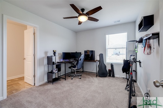 carpeted home office with ceiling fan