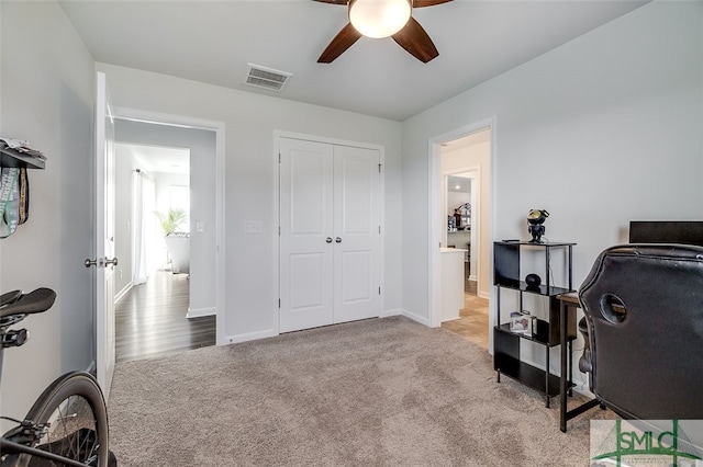 office area featuring light carpet and ceiling fan