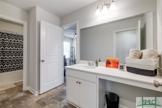 bathroom with ceiling fan, vanity, and walk in shower