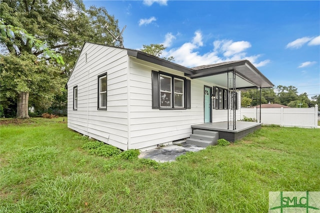 exterior space with covered porch and a lawn