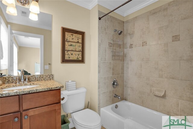 full bathroom with vanity, crown molding, tiled shower / bath, and toilet