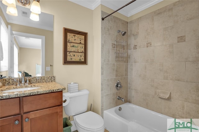 full bathroom with tiled shower / bath, ornamental molding, toilet, and vanity