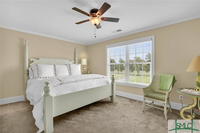 carpeted bedroom featuring ceiling fan and ornamental molding