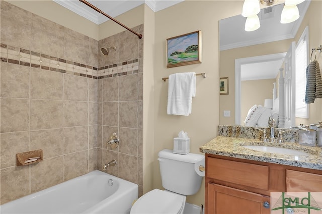 full bathroom featuring vanity, tiled shower / bath, crown molding, and toilet