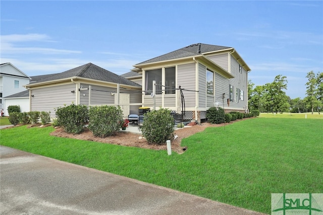 view of property exterior featuring a sunroom and a yard