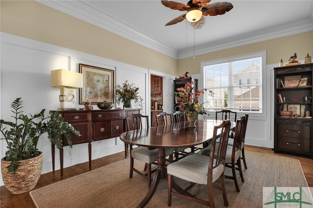 dining space featuring hardwood / wood-style flooring, ceiling fan, and ornamental molding