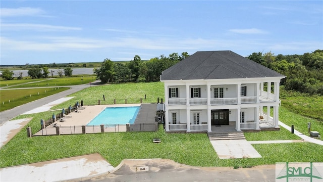 view of swimming pool featuring french doors, a patio, and a yard