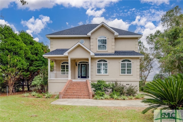 view of front of home featuring covered porch and a front yard