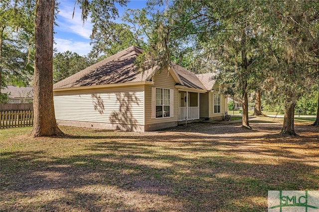 view of side of home with a yard