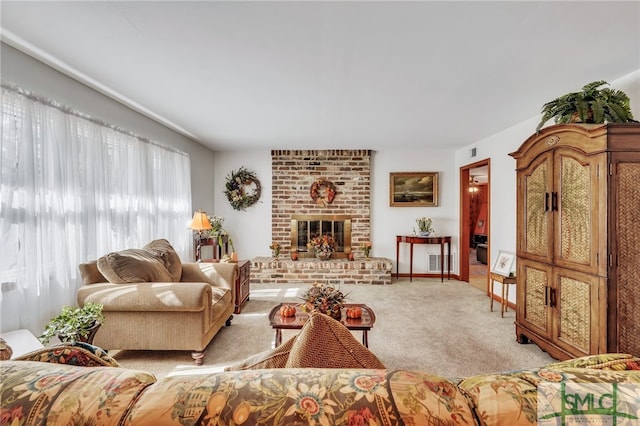 carpeted living room with a brick fireplace