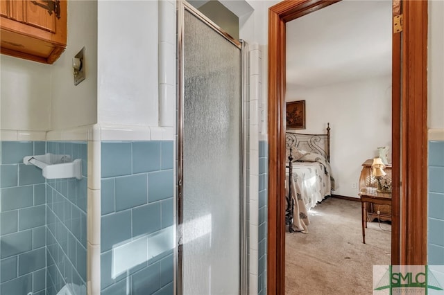 bathroom with an enclosed shower and tile walls