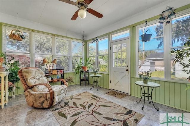 sunroom / solarium featuring ceiling fan