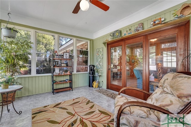 sunroom featuring ceiling fan and plenty of natural light