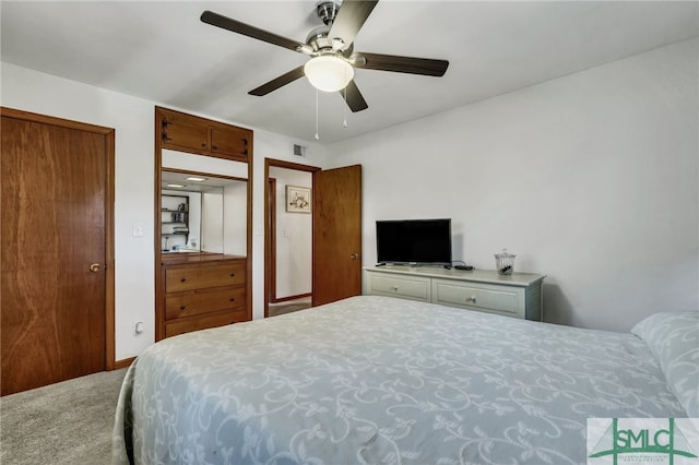 carpeted bedroom with ceiling fan and a closet