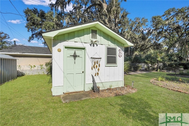 view of outdoor structure featuring a lawn