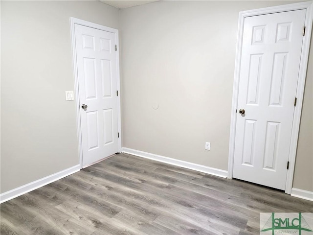 unfurnished bedroom with light wood-style floors and baseboards