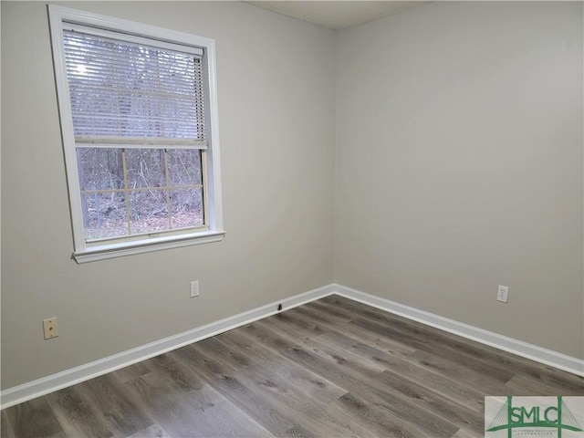 unfurnished room featuring wood finished floors and baseboards