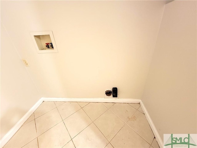 laundry room with laundry area, tile patterned flooring, hookup for a washing machine, and baseboards