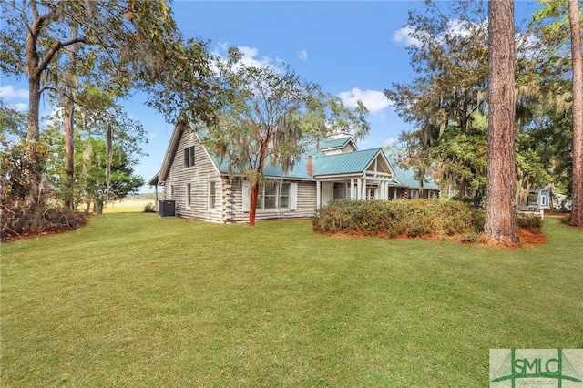 back of house featuring a yard and cooling unit